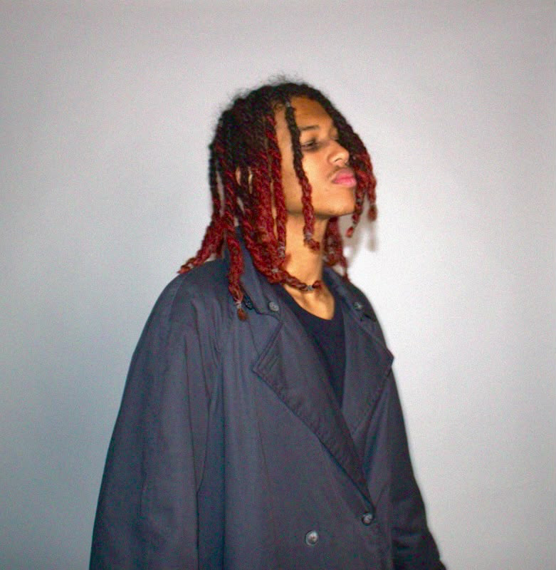 Portrait of the artist in an oversized coat